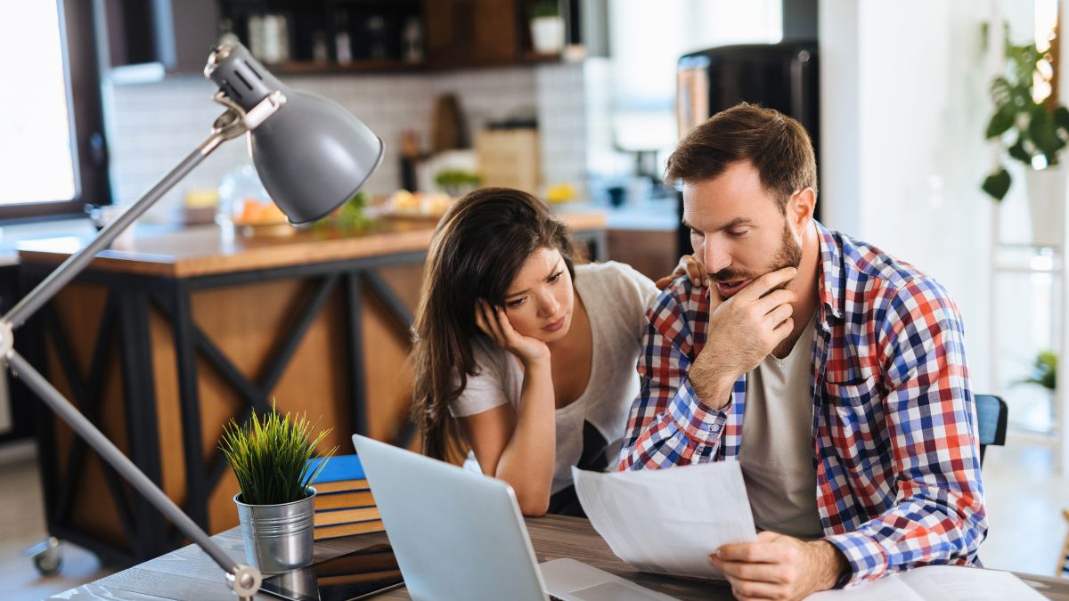 Homeowners reviewing contractor quotes